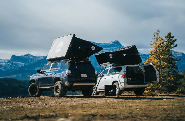 View of the roof top tent with 2 vehicles and 2 tents