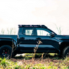 Side and Large View of the 4th gen Toyota Tacoma with a black color an an overlanding roof rack