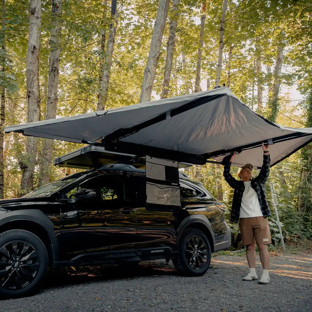 Self Standing Awning on a little car with a man under it