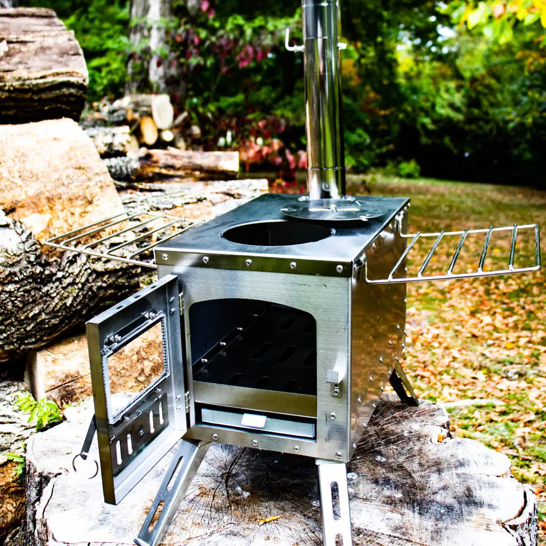 View of the portable camping wood stove with top and door open