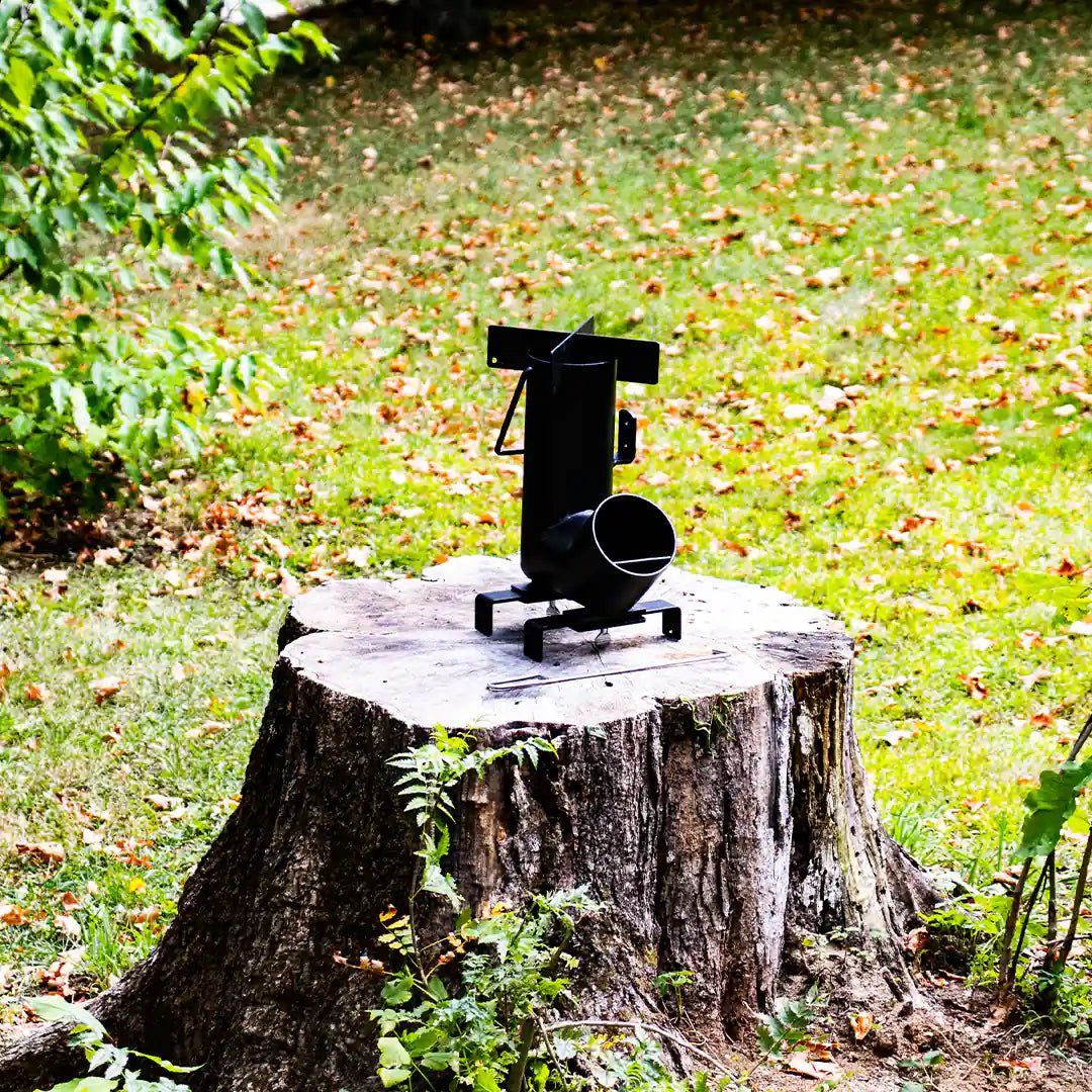 Large view of the rocket stove on a tree with grass background